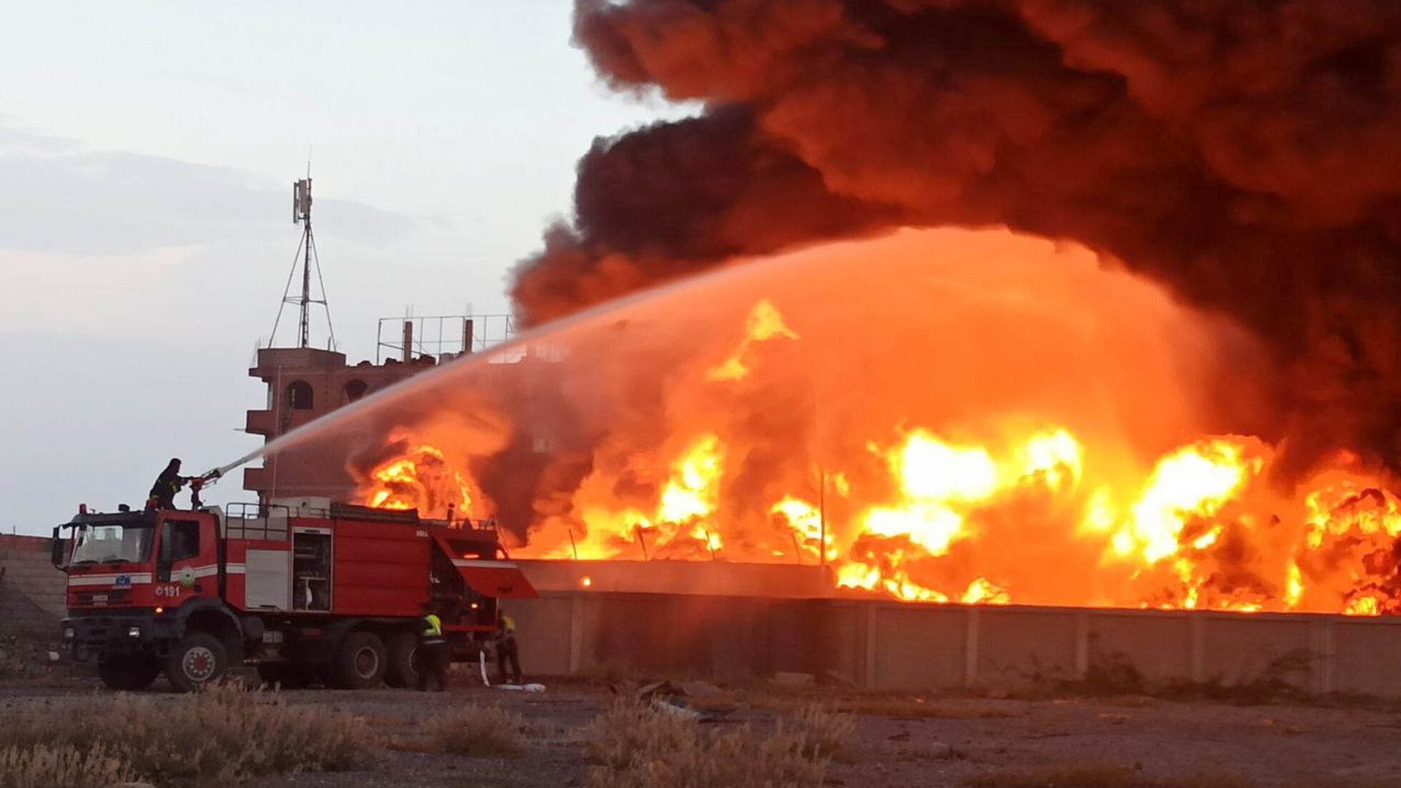 Personal de emergencias trabajan en un incendio tras los bombardeos