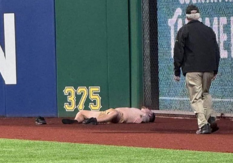 Un aficionado que se cayó del Muro Clemente de 6,4 metros en el PNC Park es atendido por el personal de entrenamiento de los Piratas y los Cachorros, así como por personal de PNC. Foto AP/Gene J. Puskar