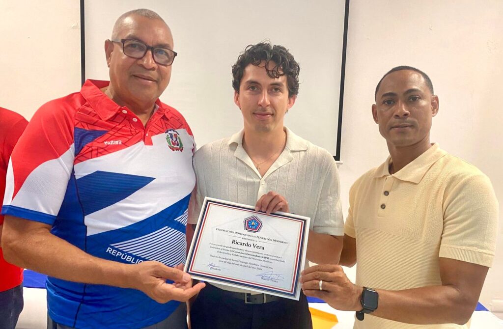 El instructor español Ricardo Vera recibe un reconocimiento de Kenny Núñez y Marcelo Derouville, presidente y tesorero de Fedopem.